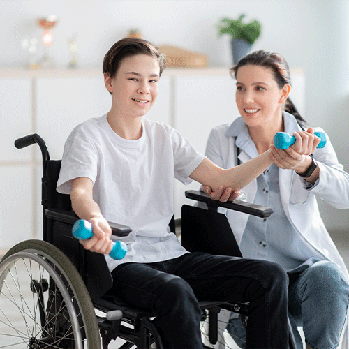 Young person in a wheelchair exercising with a support nurse, representing continence care and disability support services in Ipswich.